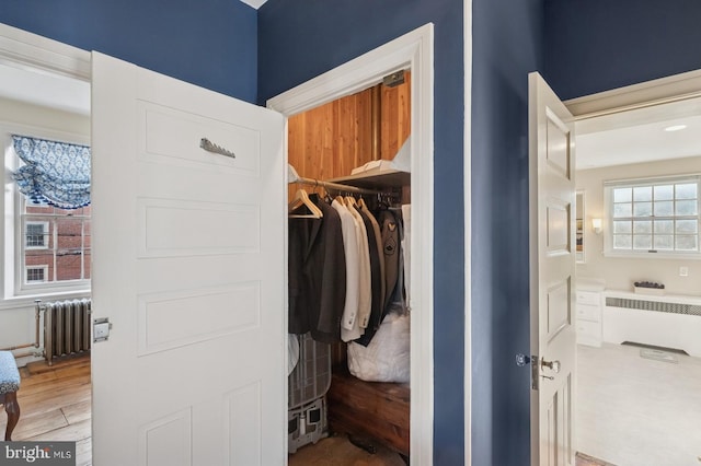 closet with radiator and radiator heating unit