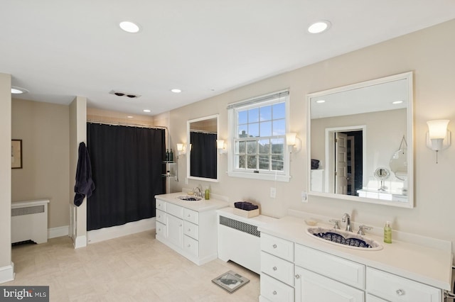 bathroom featuring recessed lighting, visible vents, radiator, and vanity