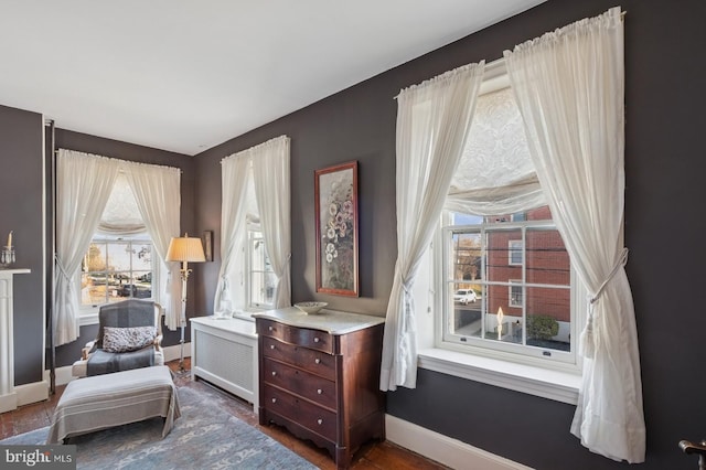sitting room featuring baseboards and dark wood finished floors