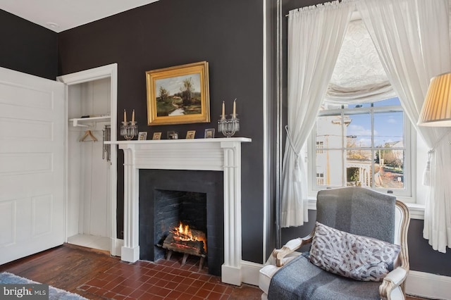 living area with a fireplace with flush hearth
