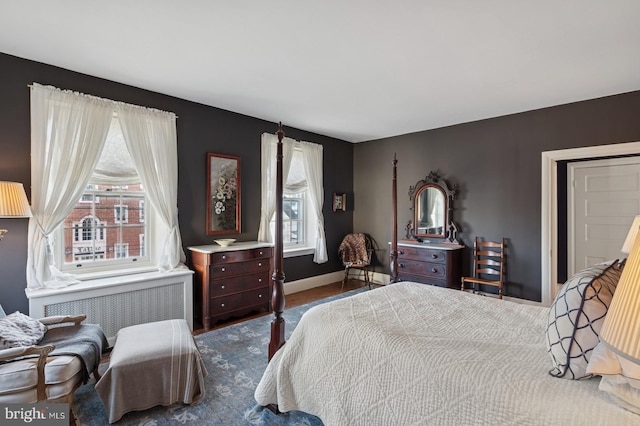 bedroom featuring baseboards and radiator
