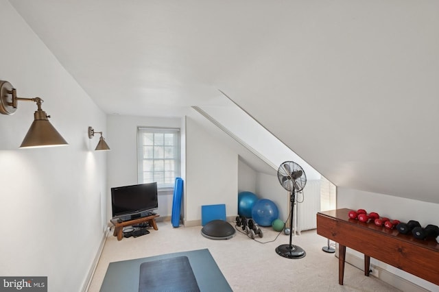 workout area featuring carpet and vaulted ceiling