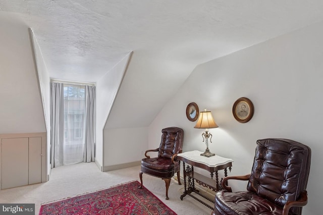 sitting room featuring carpet and lofted ceiling