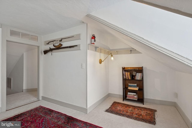 bonus room with carpet floors, baseboards, and visible vents