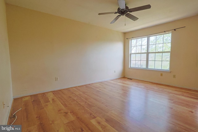 unfurnished room with light wood-style floors, baseboards, and ceiling fan