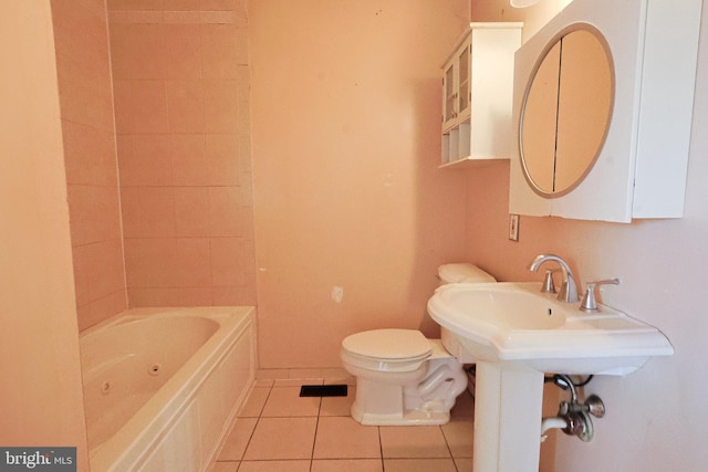 bathroom with tile patterned flooring, baseboards, and toilet