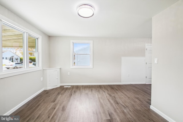 914 Andrews Rd, Glen Burnie, MD 21060 - empty room with wood finished floors, healthy amount of natural light, and baseboards