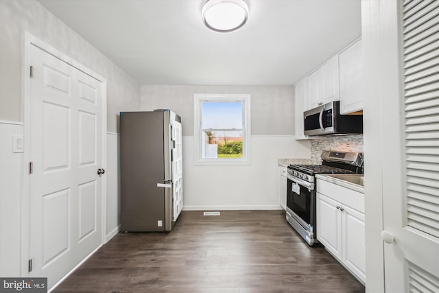 914 Andrews Rd, Glen Burnie, MD 21060 - kitchen with appliances with stainless steel finishes, white cabinetry, decorative backsplash, dark wood-style floors, and light countertops