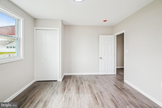 914 Andrews Rd, Glen Burnie, MD 21060 - unfurnished bedroom with wood finished floors, baseboards, and a closet
