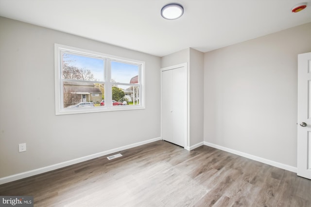 914 Andrews Rd, Glen Burnie, MD 21060 - unfurnished bedroom with wood finished floors, baseboards, and a closet