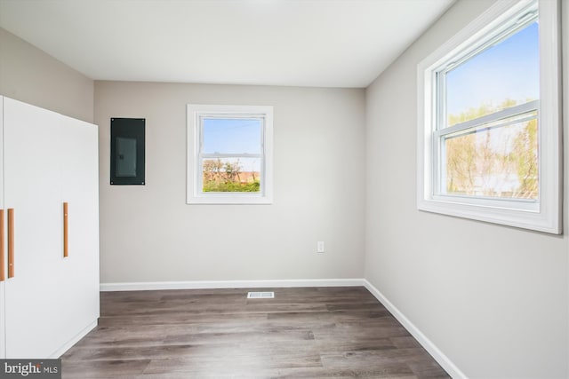 914 Andrews Rd, Glen Burnie, MD 21060 - empty room featuring electric panel, plenty of natural light, and wood finished floors
