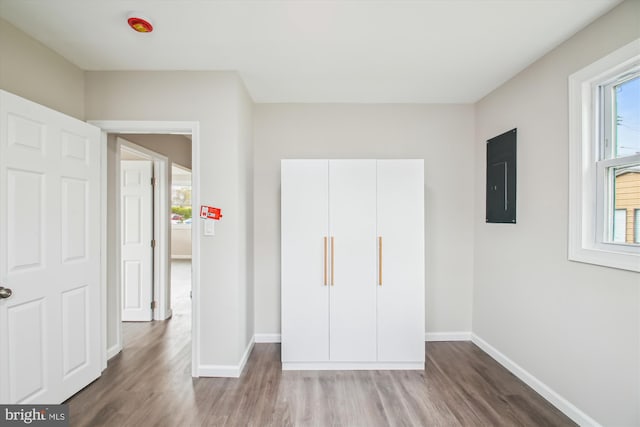 914 Andrews Rd, Glen Burnie, MD 21060 - unfurnished bedroom with electric panel, wood finished floors, and baseboards