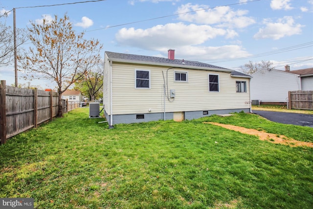 914 Andrews Rd, Glen Burnie, MD 21060 - back of house with central AC unit and a chimney
