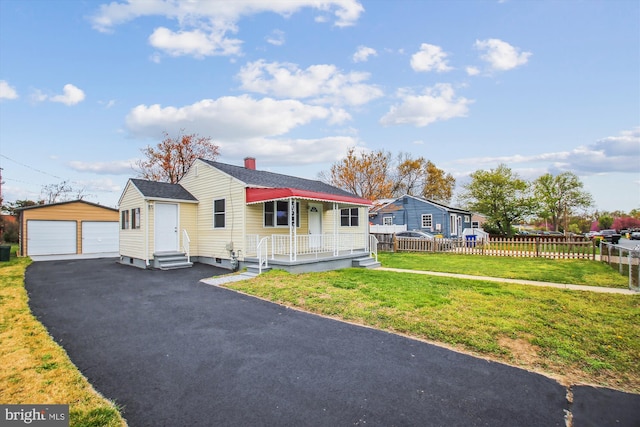914 Andrews Rd, Glen Burnie, MD 21060 - view of front of house featuring an outbuilding, a detached garage, covered porch, a chimney, and entry steps