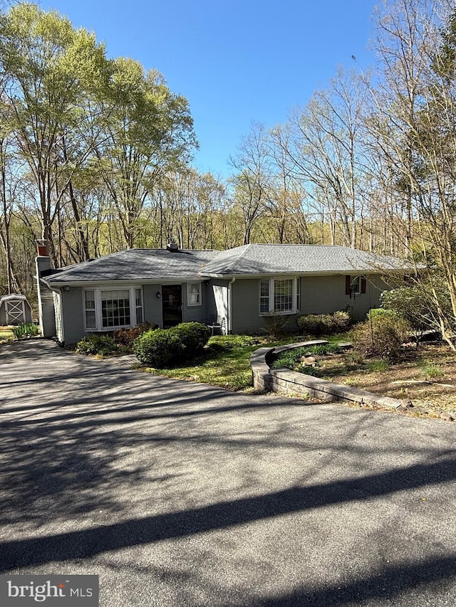 single story home with driveway and a garage
