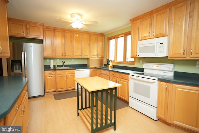 kitchen featuring a sink, ceiling fan, light wood-type flooring, and white appliances