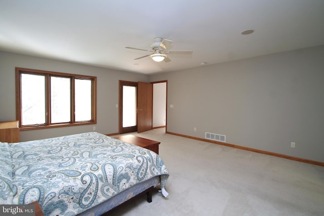 bedroom with light colored carpet, baseboards, and ceiling fan