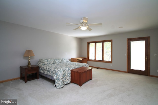 bedroom with light carpet, baseboards, and a ceiling fan