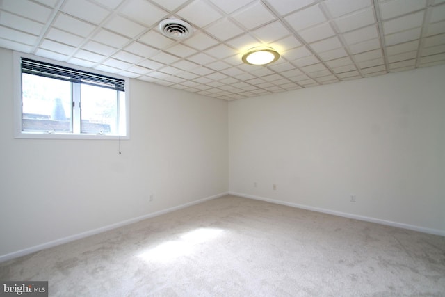 carpeted empty room featuring baseboards