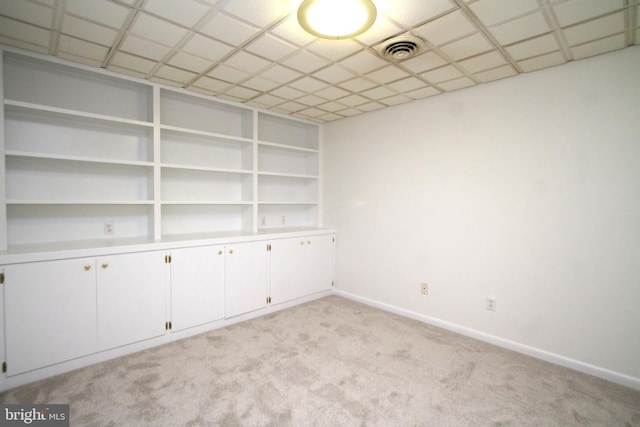 spare room with light carpet and baseboards