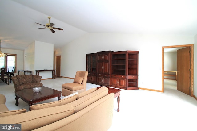 living room with light colored carpet, lofted ceiling, ceiling fan, and baseboards