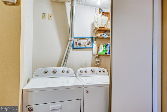 washroom featuring laundry area and washing machine and dryer
