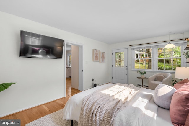 bedroom featuring a baseboard radiator and light wood-type flooring