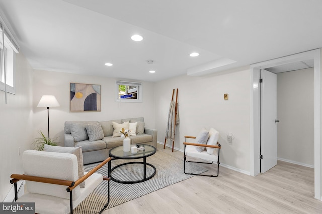 living room with recessed lighting, light wood-style flooring, and baseboards
