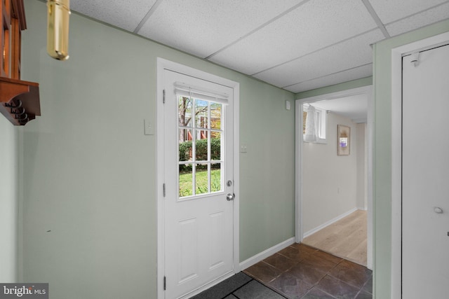 entryway with baseboards and a drop ceiling