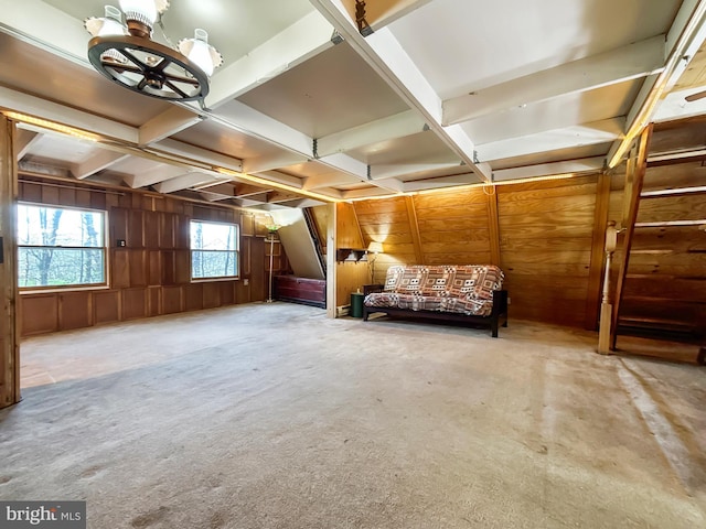 living area with wood walls, carpet, beamed ceiling, and coffered ceiling