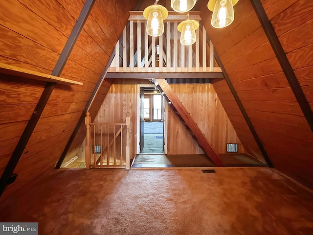 bonus room with wood walls, vaulted ceiling, and carpet floors