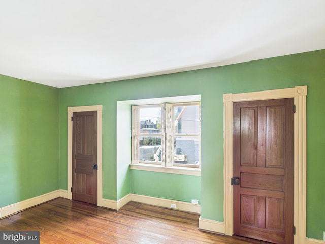 interior space featuring wood finished floors and baseboards