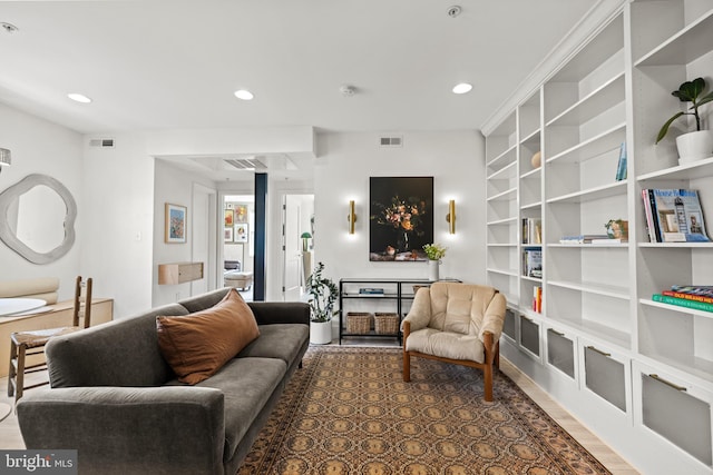 living area featuring built in features, recessed lighting, and visible vents