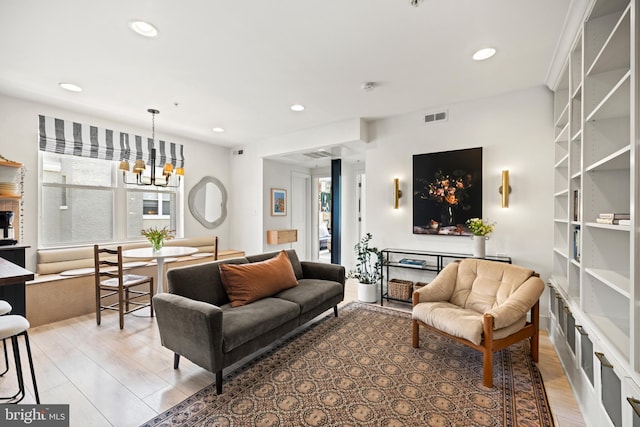 living room featuring recessed lighting, visible vents, an inviting chandelier, and light wood-type flooring
