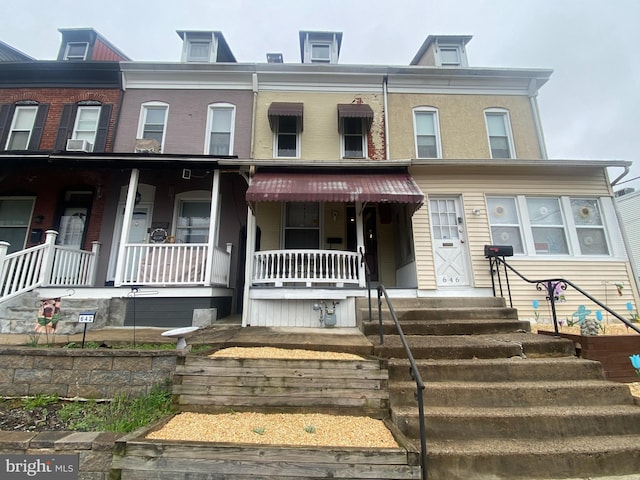 view of property featuring covered porch