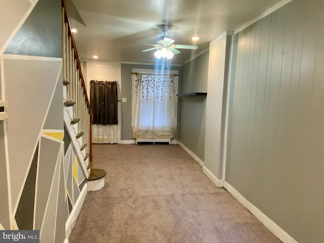interior space with carpet floors, baseboards, and ceiling fan