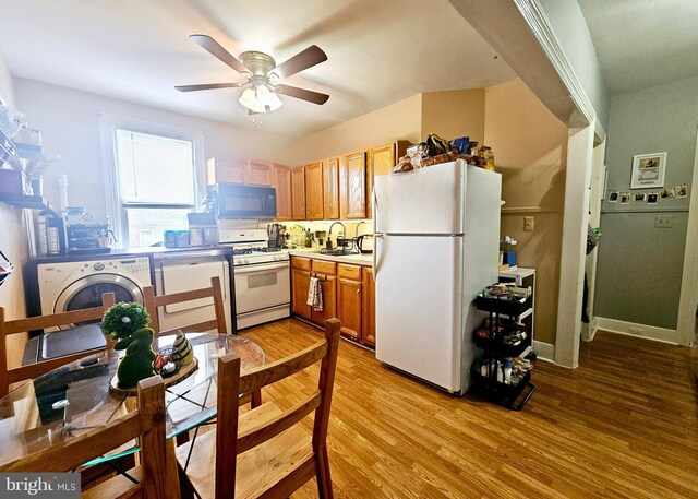 801 Spruce St, Trenton, NJ 08638 - kitchen with light countertops, light wood-type flooring, white appliances, a ceiling fan, and washer / dryer