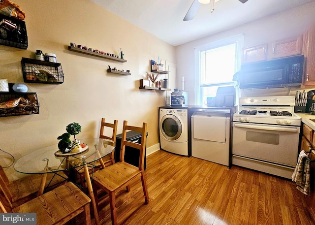 801 Spruce St, Trenton, NJ 08638 - kitchen with a ceiling fan, black microwave, light wood finished floors, white gas range, and washing machine and clothes dryer