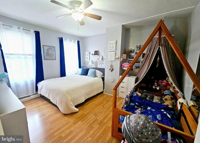801 Spruce St, Trenton, NJ 08638 - bedroom featuring ceiling fan, a baseboard radiator, and wood finished floors