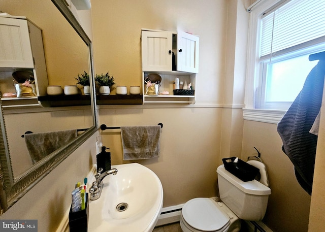 801 Spruce St, Trenton, NJ 08638 - bathroom with a baseboard radiator, a sink, and toilet