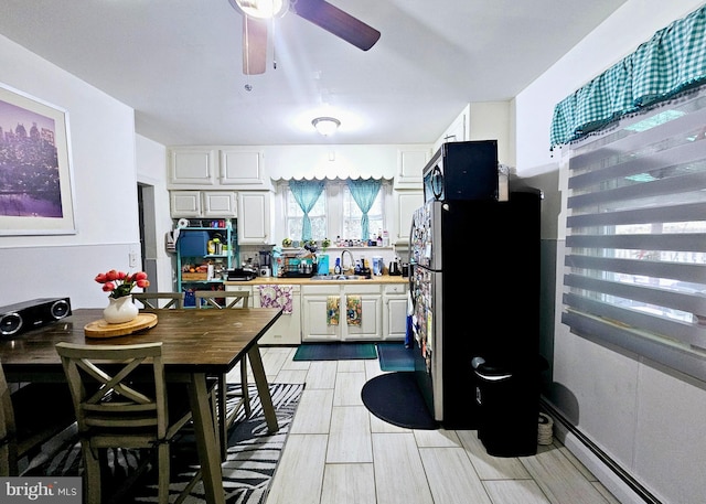 801 Spruce St, Trenton, NJ 08638 - kitchen with a sink, ceiling fan, freestanding refrigerator, black microwave, and white cabinetry