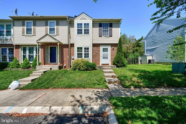 312 Talbot Ct, Abingdon, MD 21009 - view of property with an outbuilding, central air condition unit, brick siding, a front lawn, and a storage unit