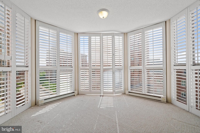 unfurnished sunroom with a baseboard radiator