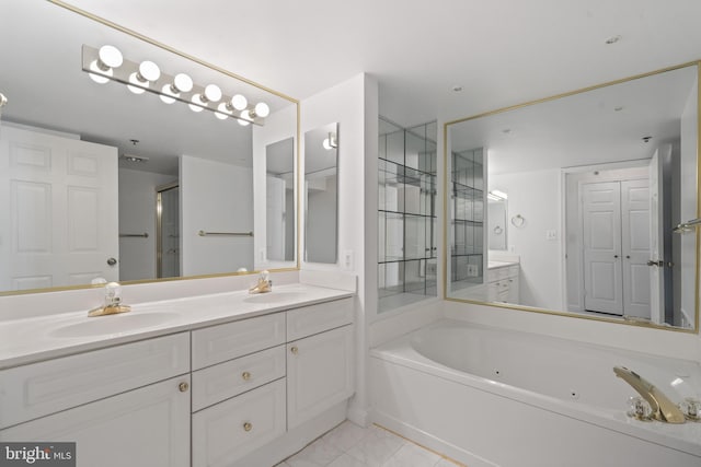 bathroom featuring double vanity and a whirlpool tub