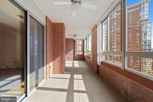 hallway with brick wall and tile patterned flooring