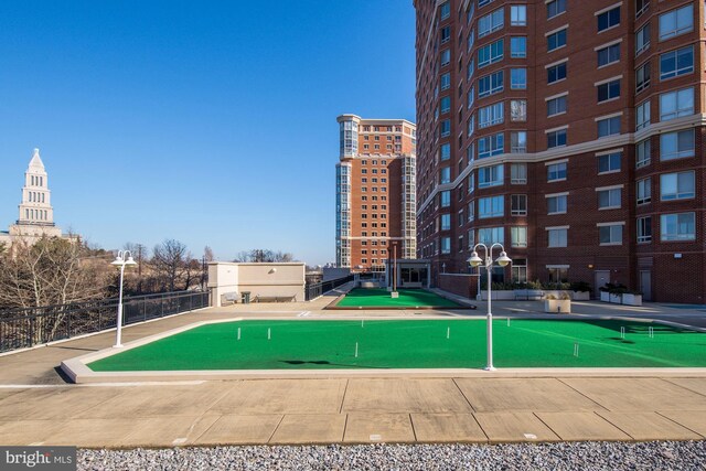 view of swimming pool featuring an area to practice putting