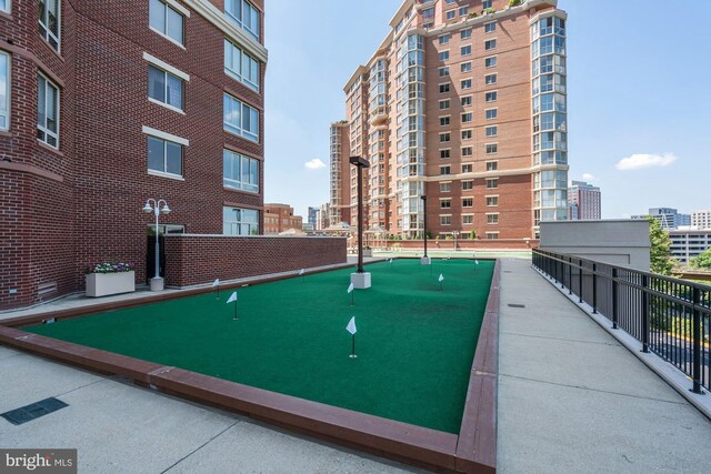 view of home's community with a putting area