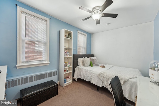 bedroom with radiator, carpet flooring, and a ceiling fan