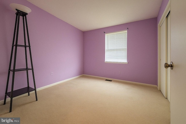 unfurnished bedroom with baseboards, a closet, visible vents, and carpet