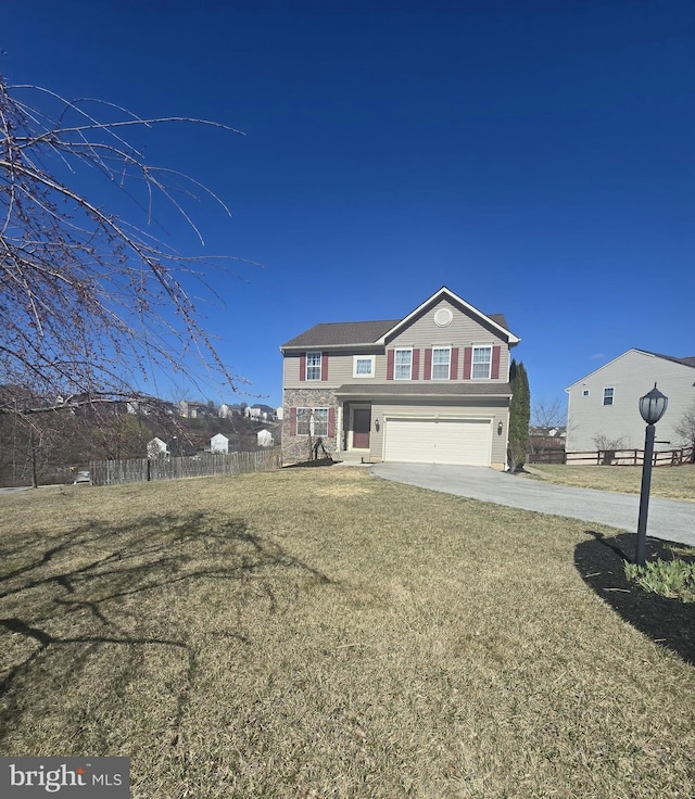 traditional home featuring driveway, a garage, fence, and a front lawn